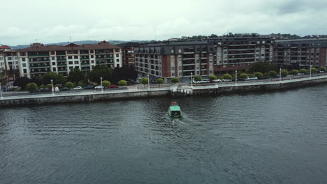 aerial view of a town with a river and ferry