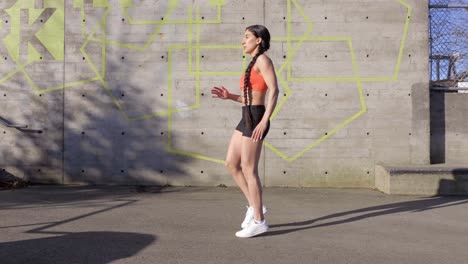 wide shot young athletic woman kicking martial arts exercise