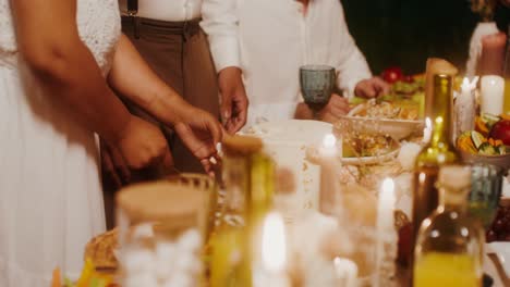 couple cutting wedding cake at outdoor reception