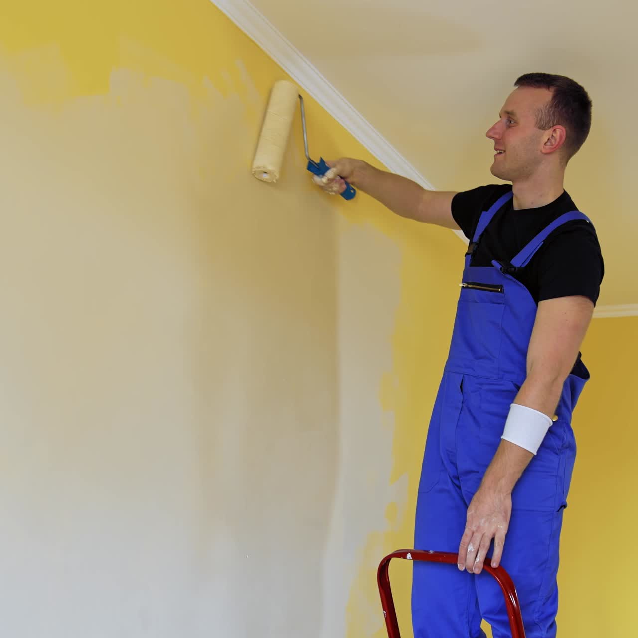 Young colorist doing new renovation in house. Painter decorating with color indoor