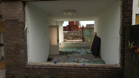 shattered glass windows on the floor of a house during demolition