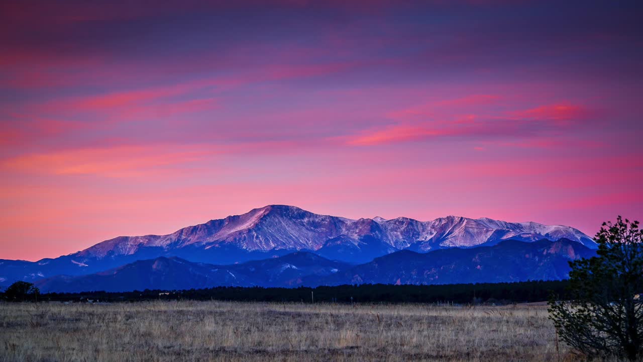 Morning light time lapse of pink sky over Pikes Peak, Colorado.