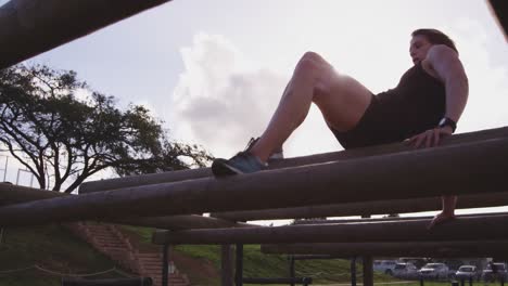 young woman training at an outdoor gym bootcamp