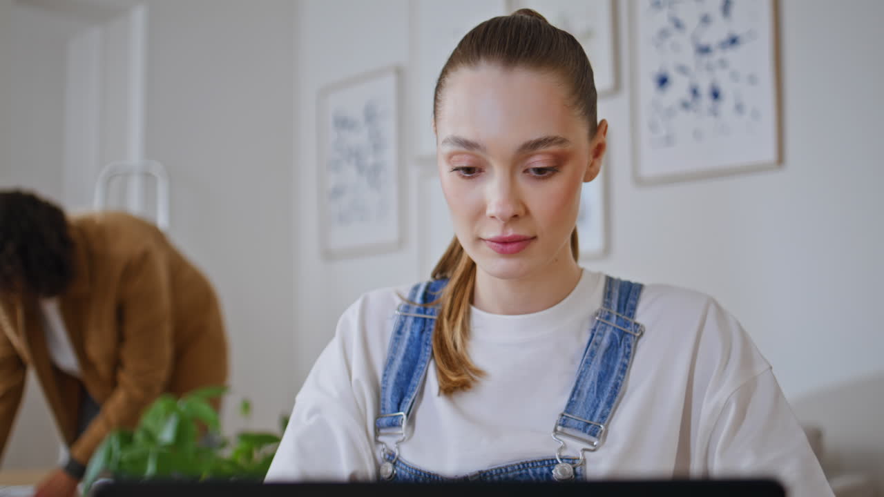 Wife freelancer working laptop in stylish room closeup. Man husband tidying home
