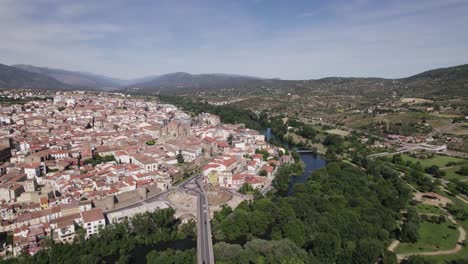 aerial orbiting shot of scenic municipally plasencia near caceres by jerte river, spain