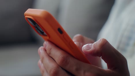 person holding an orange phone