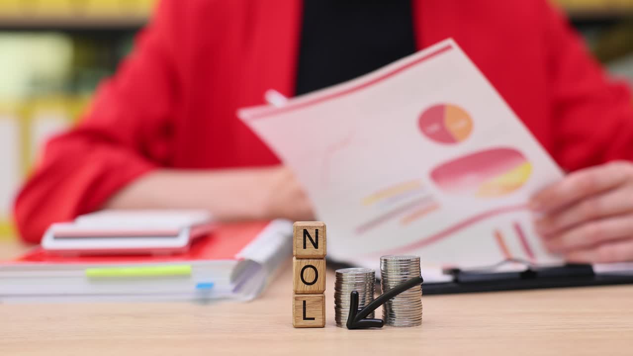 NOL Concept with Coins and Financial Report