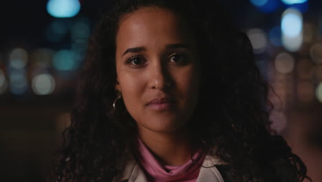 portrait-of-beautiful-young-mixed-race-woman-on-rooftop-at-night-with-bokeh-city-lights-in-urban-skyline-background