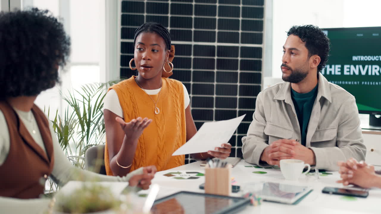 Diverse Business Team Discussing Sustainability in a Modern Office Meeting