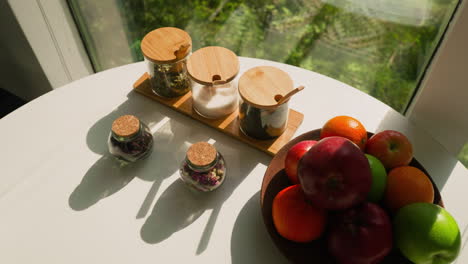 jars with herbs and fruit plate on table. nurturing and invigorating start to day becomes cherished tradition. healthy lifestyle during vacation