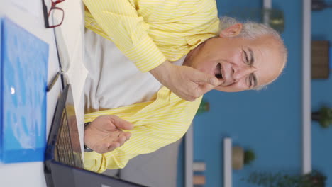 vertical video of home office worker old man teeth aches and pains.