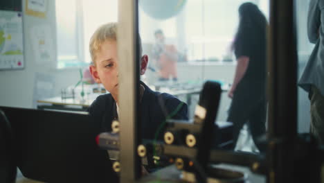 student using laptop in a science classroom