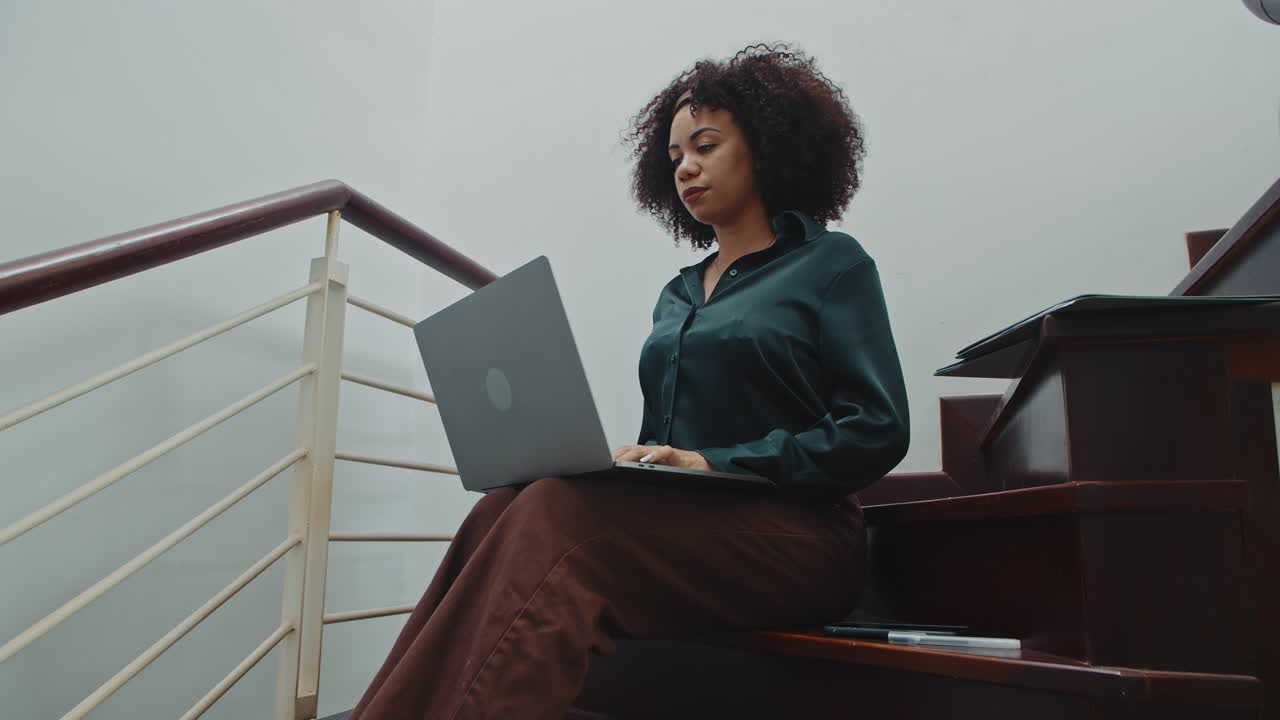 Latin Freelancer Working on Laptop on Stairs