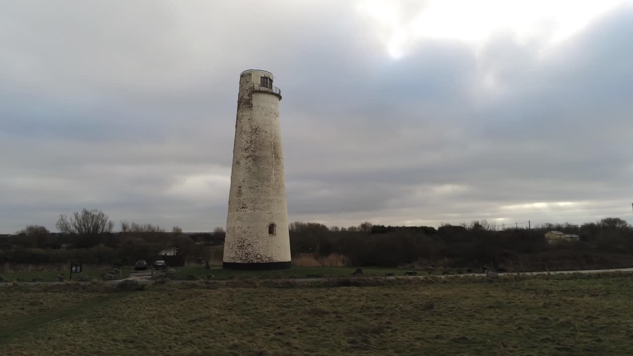 Historic Leasowe Lighthouse maritime beacon landmark aerial coastal countryside Wirral view low right dolly
