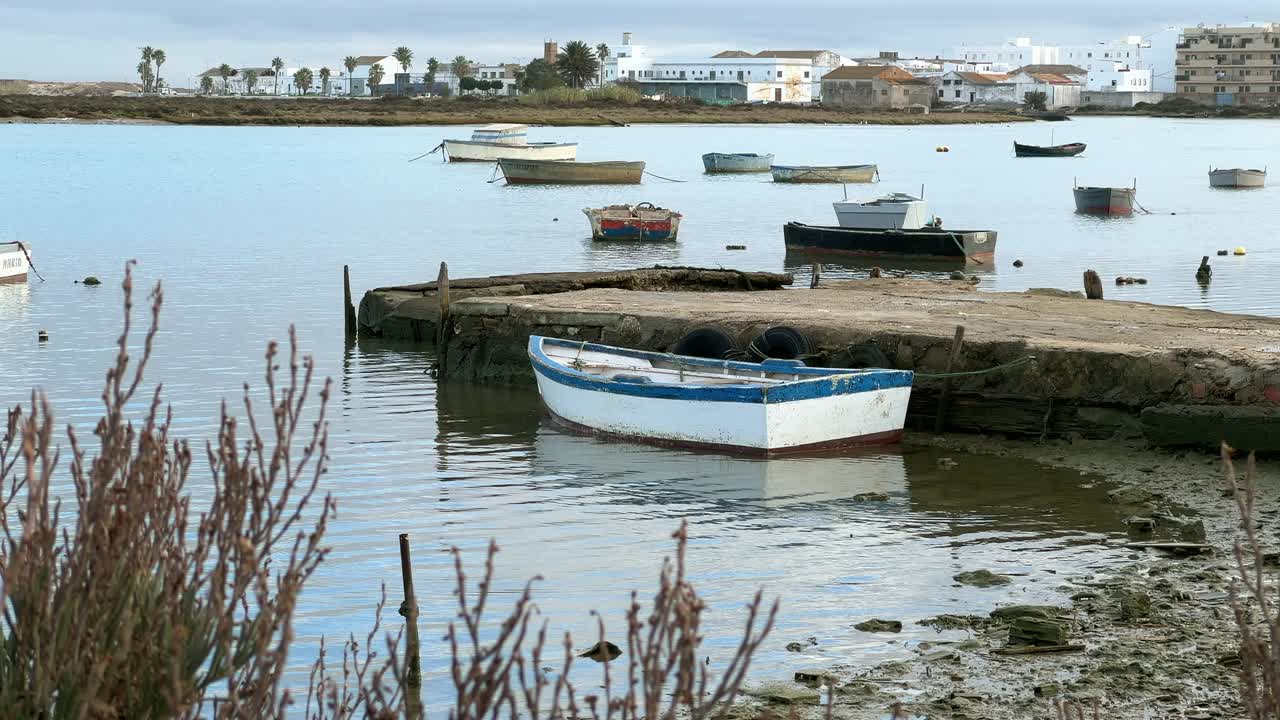 Static view of boat moored at a deserted pier. Daylight