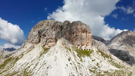 craggy mountain with caves near the tre cime di lavaredo on a sunny day in veneto, italy