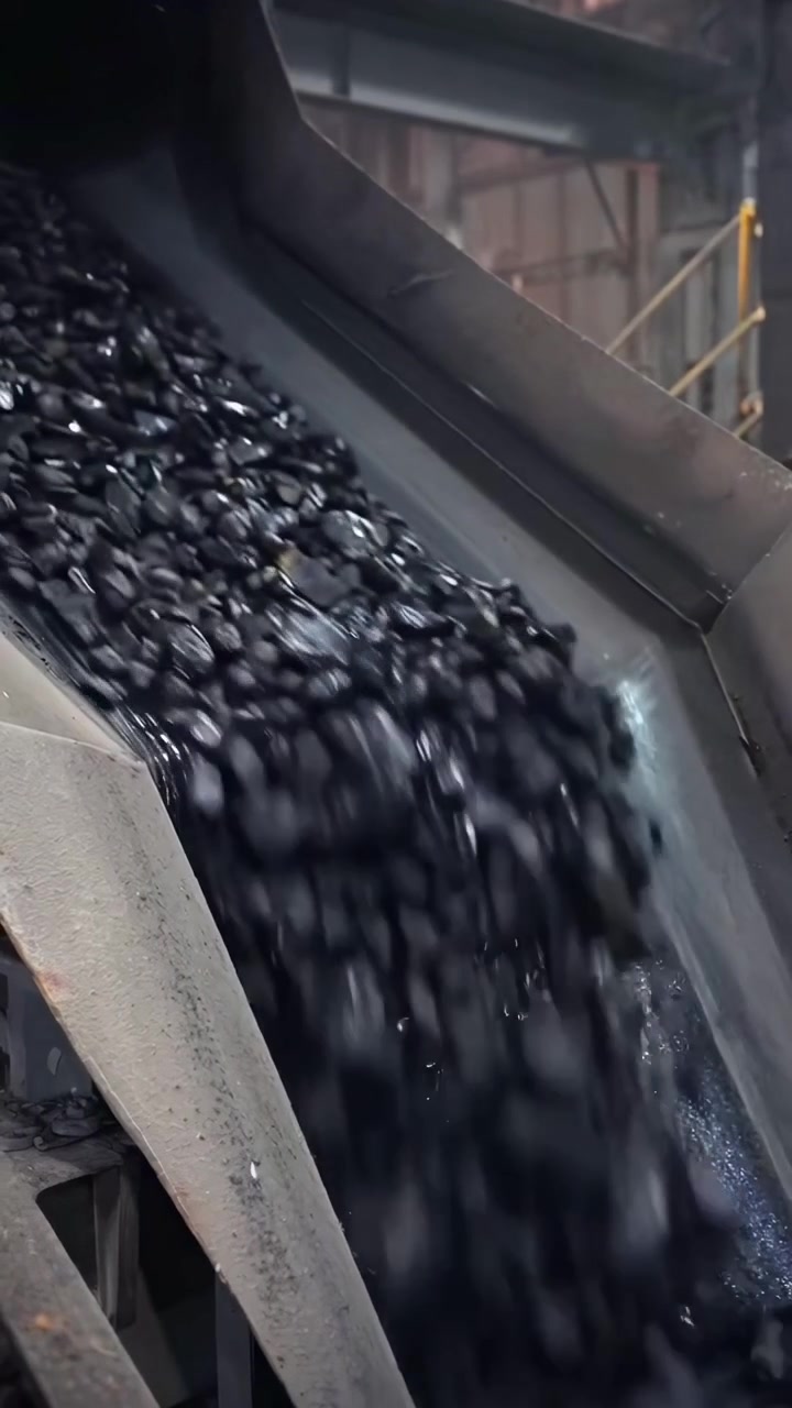 Industrial Conveyor Belt Transporting Coal in a Factory