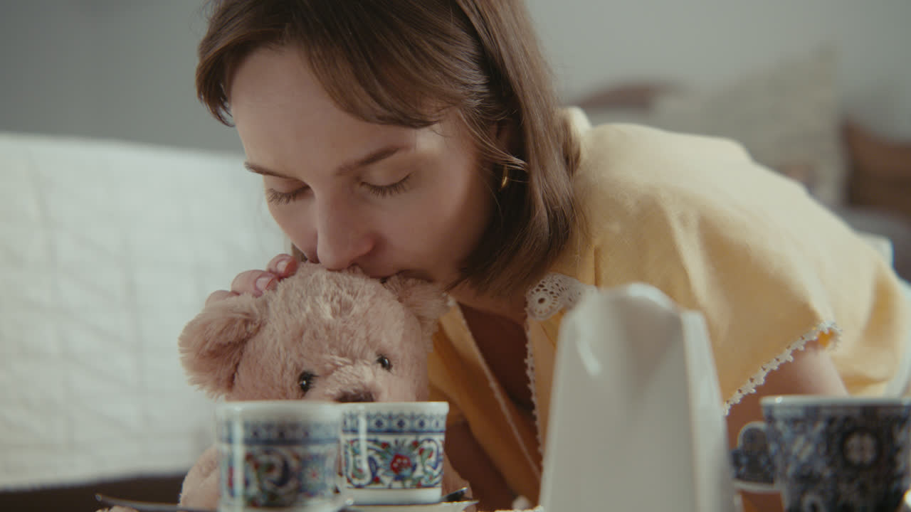 A girl playing with dolls in her room