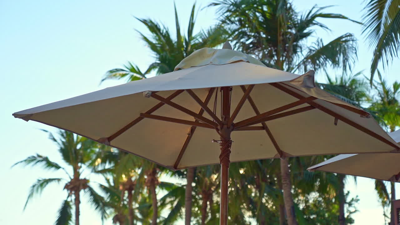 A large shade umbrella punctuates the sky