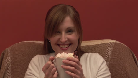 stock footage of a woman on a couch drinking coffee