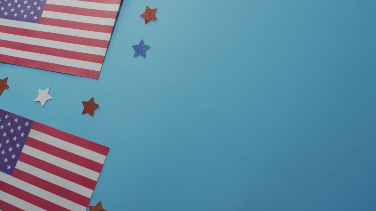 American flags with red and blue stars lying on blue background