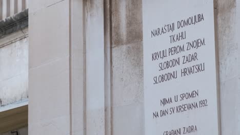 A-sign-carved-in-stone-on-People's-square-in-Zadar,-Croatia-that-citizens-of-Zadar-erected-in-memory-of-1992-and-free-town