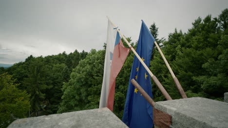 close shot of two flags fluttering in the wind