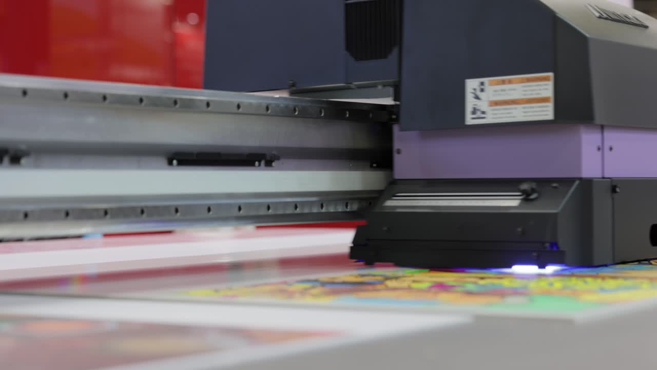Modern Digital Large format UV printer. Printing production technologies. UV pinning is the process of applying a dose of low intensity ultraviolet light to a UV curable ink