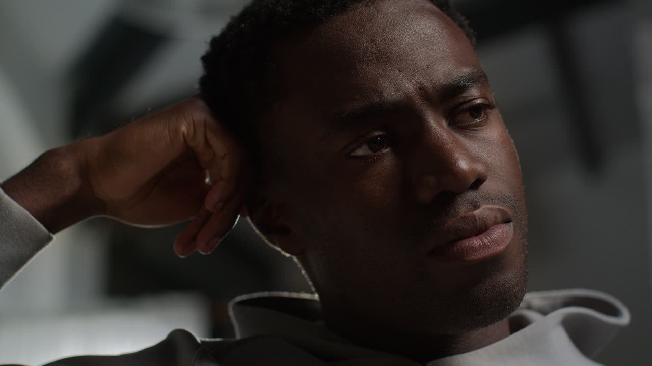 Close Up Low Key Lighting Shot Of Unhappy And Depressed Young Man With Head In Hands Shaking Head 2