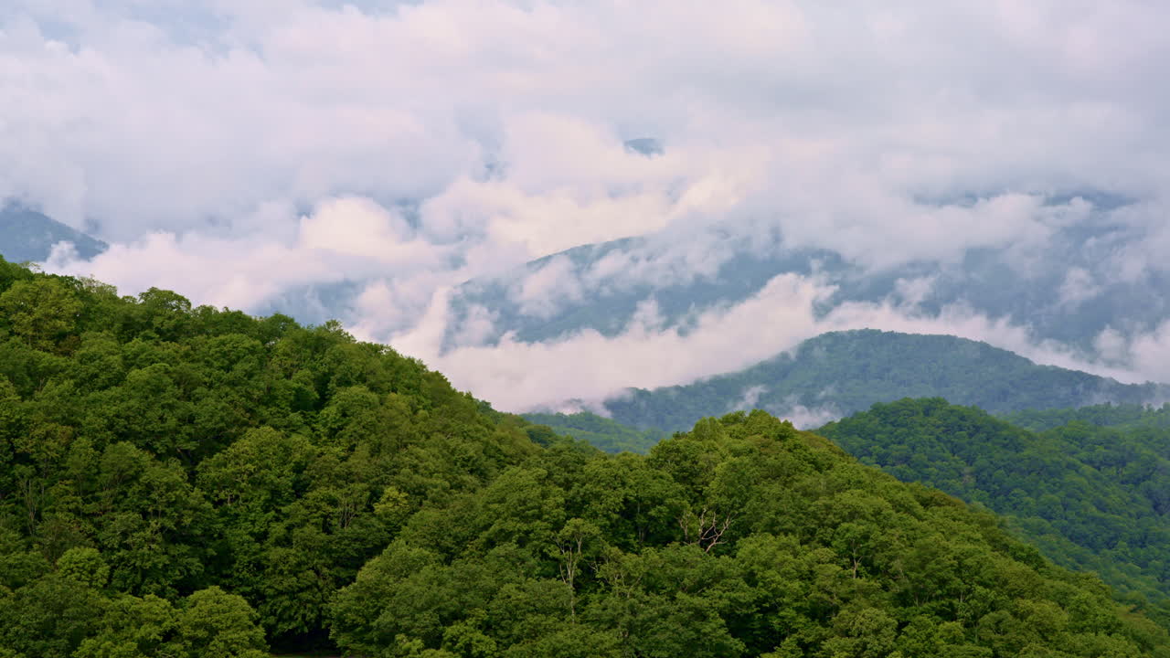 Enchanting drone visuals of the Smoky Mountains veiled in mist and clouds