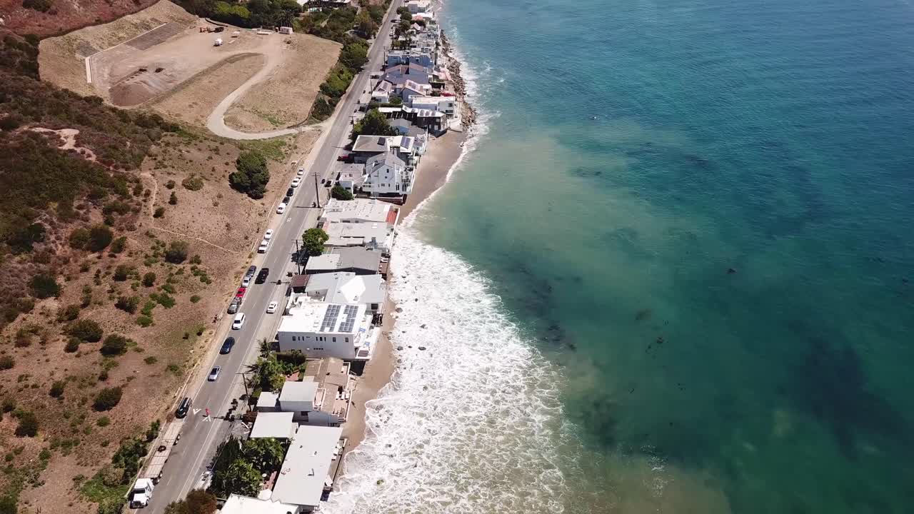Luxury homes and houses with ocean view in Malibu. Expensive real estate houses with private sandy beach. Aerial top down flyover. California,USA.