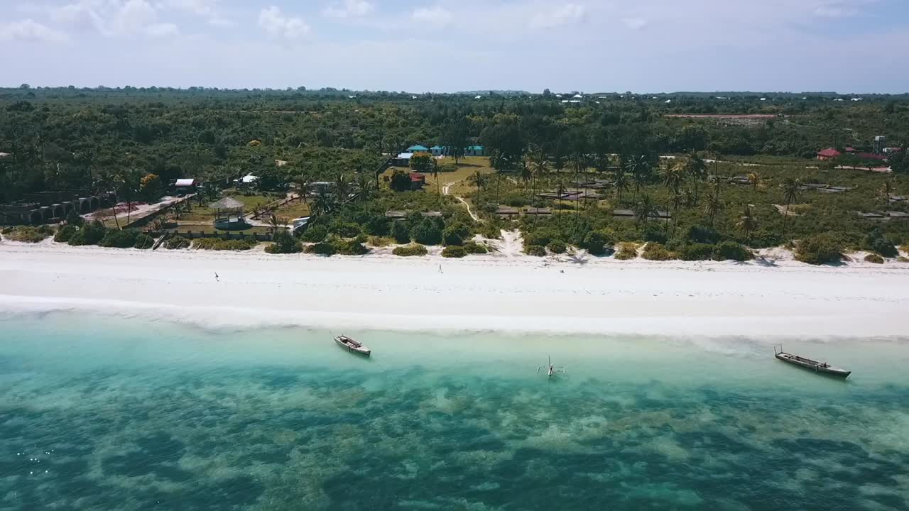 Smooth aerial flight fly forwards drone shot over nice crystal clear turquoise water reef to a
Paradise white sand dream beach Zanzibar, Africa 2019