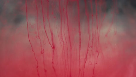 abstract red liquid swirling in water