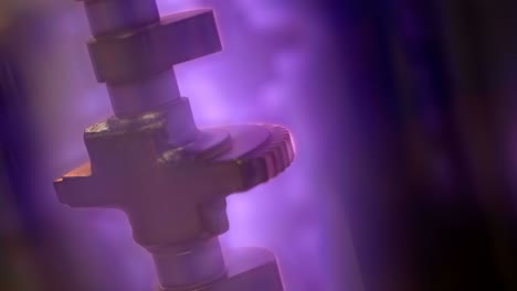 the camshaft of a car engine in a vacuum and a beautiful mesmerizing plasma