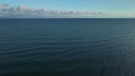 Beautiful-aerial-view-of-a-calm-ocean-on-the-coast-of-Hokkaido,-Japan