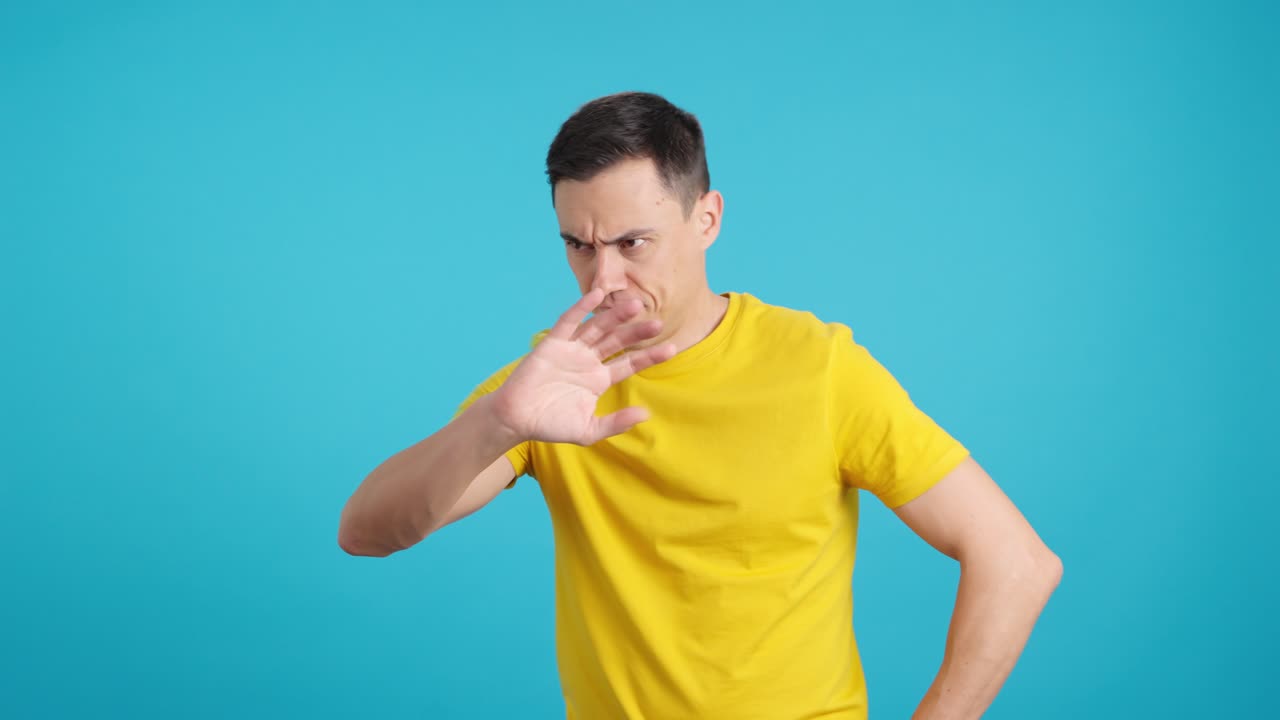 Man in yellow shirt with various facial expressions