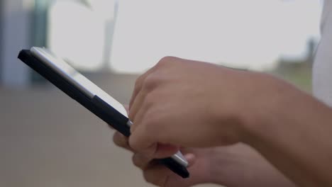 Side-view-of-male-hands-using-modern-tablet