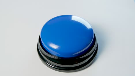 young woman pushing blue button with a finger and palm of her hand. press a round glossy button, top view. activation, launching something. turn on and off.