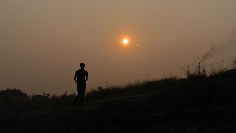 cinematic establisher view of silhouetted runner, high contrast, sunset