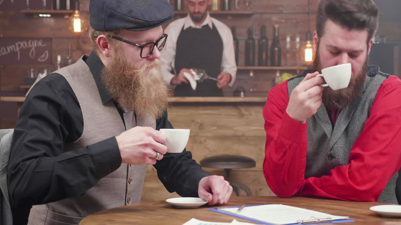Businessmen signing a contract in a cafe