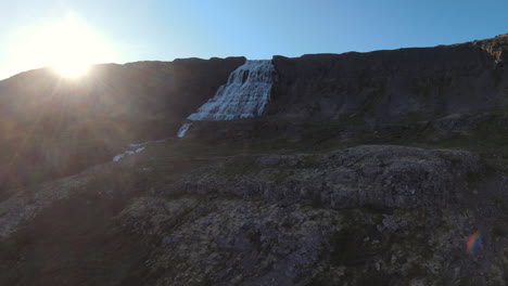 rising sun at dynjandi waterfall, iceland