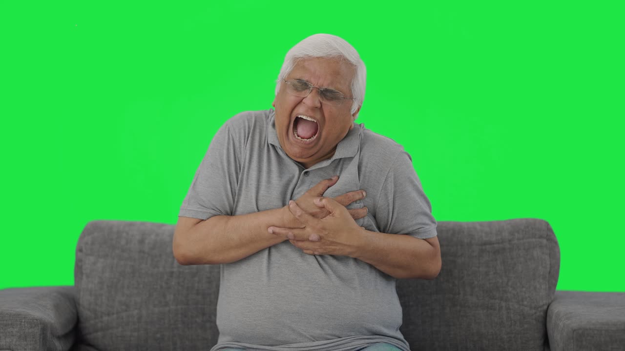 Sick Indian old man having a heart attack Green screen