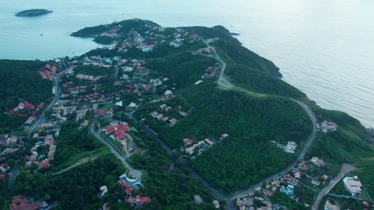 Aerial view establishing the tiled houses in B&uacute;zios, Brazil at sunrise with soft light