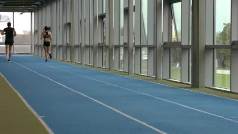 couple racing on indoor track