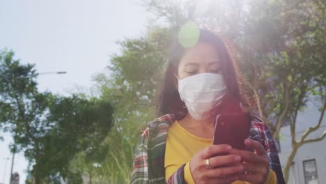 Mixed-race-woman-wearing-medical-coronavirus-mask-on-the-street