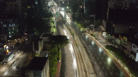 Low-flying-aerial-dolly-shot-flying-above-empty-multi-lane-highway-through-urban-city-center-with-skyscrapers-in-Jakarta