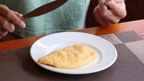 person eating omelette