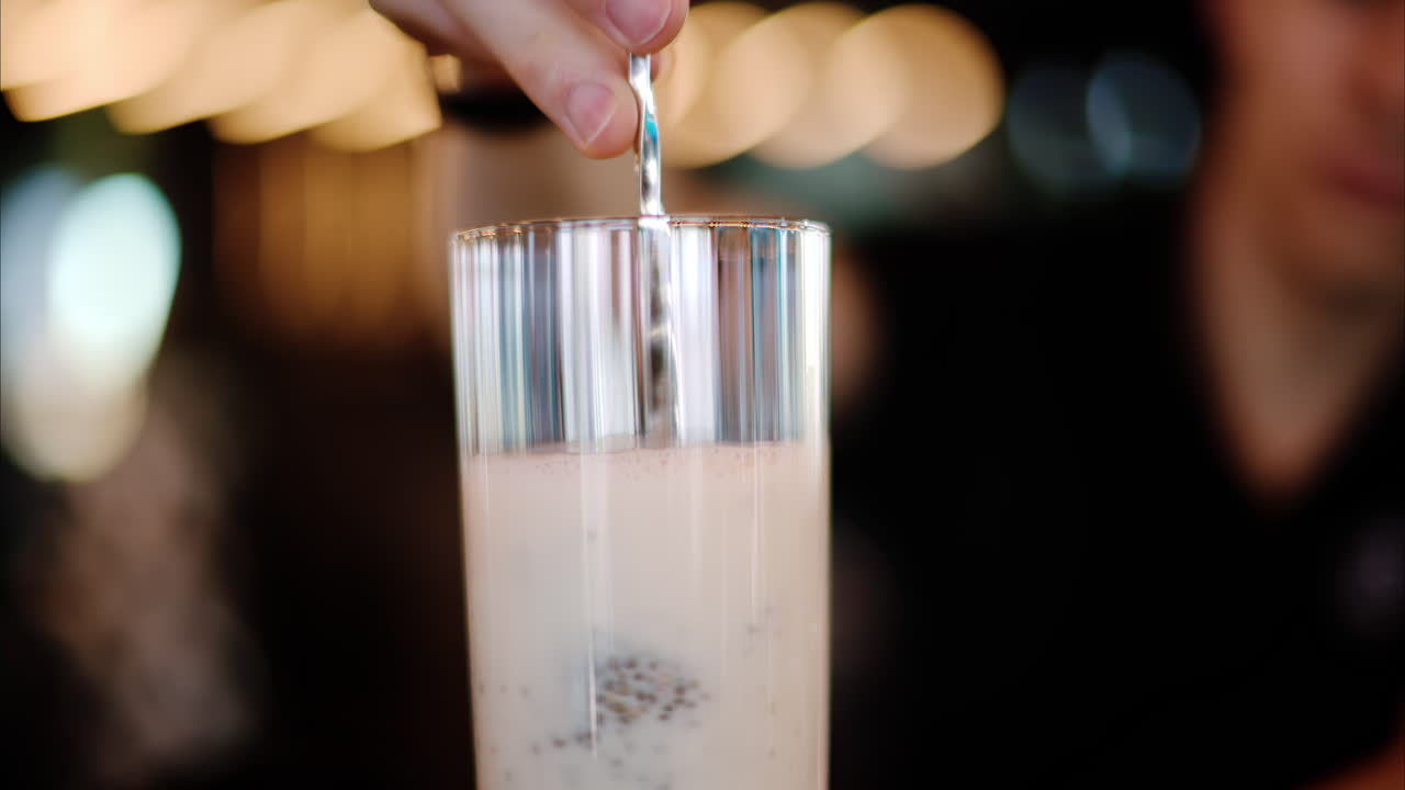 Man putting and mixing a chia seed pudding in a drink