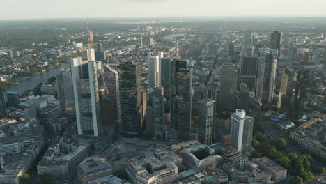 AERIAL:-Beautiful-Frankfurt-am-Main,-Germany-Cityscape-in-Soft-Summer-Afternoon-light-Haze-with-Green-Trees-in-June-2020