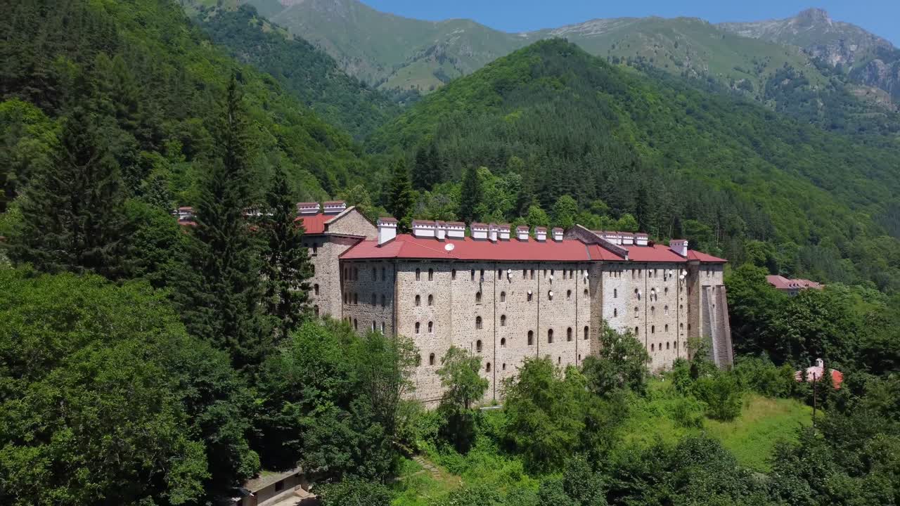 Close-up drone view of Rila Monastery with Rila Mountains and forest, Bulgaria